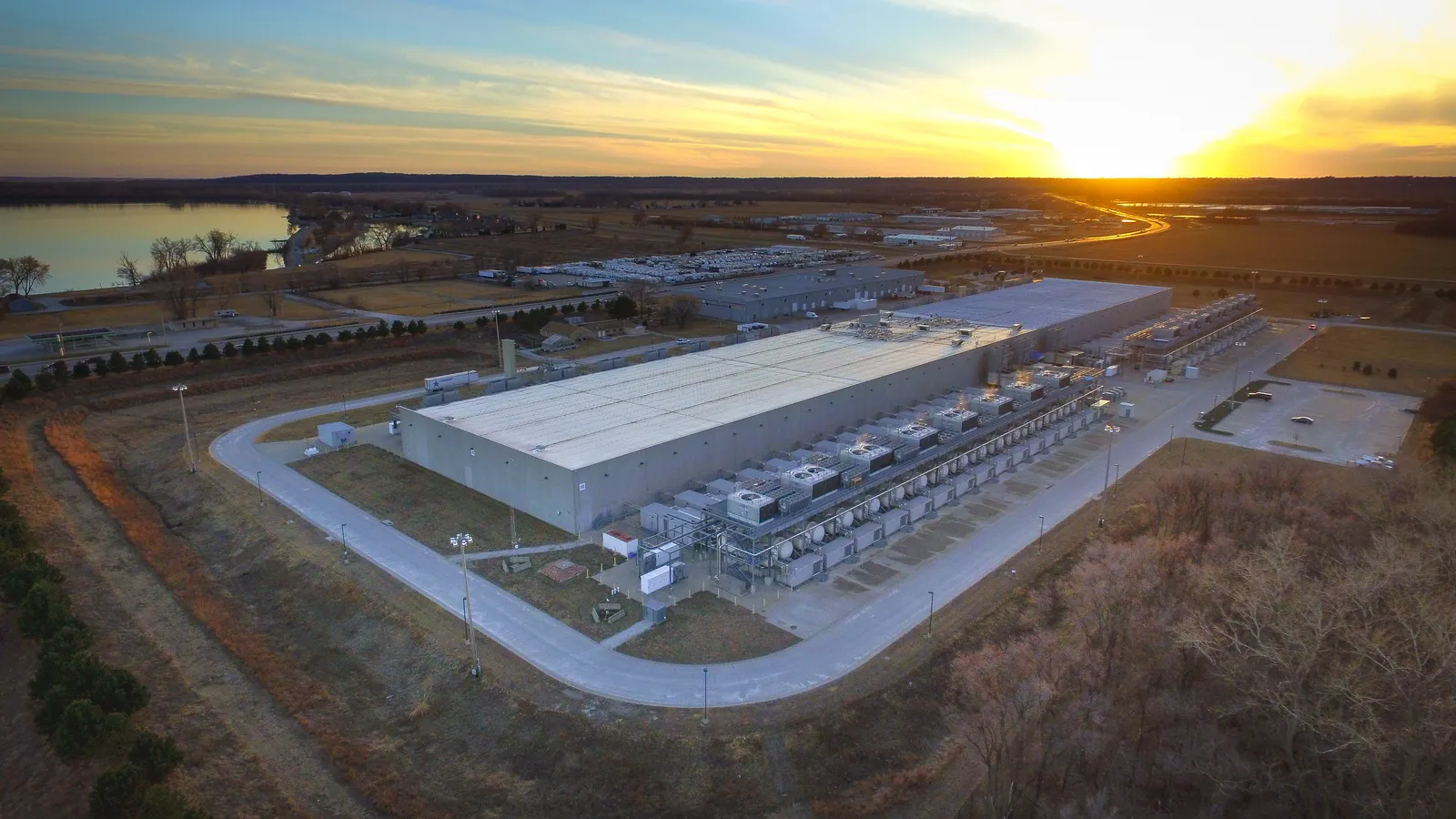 Aerial view of Google's Council Bluffs, Iowa data center campus and cooling yards at sunset.