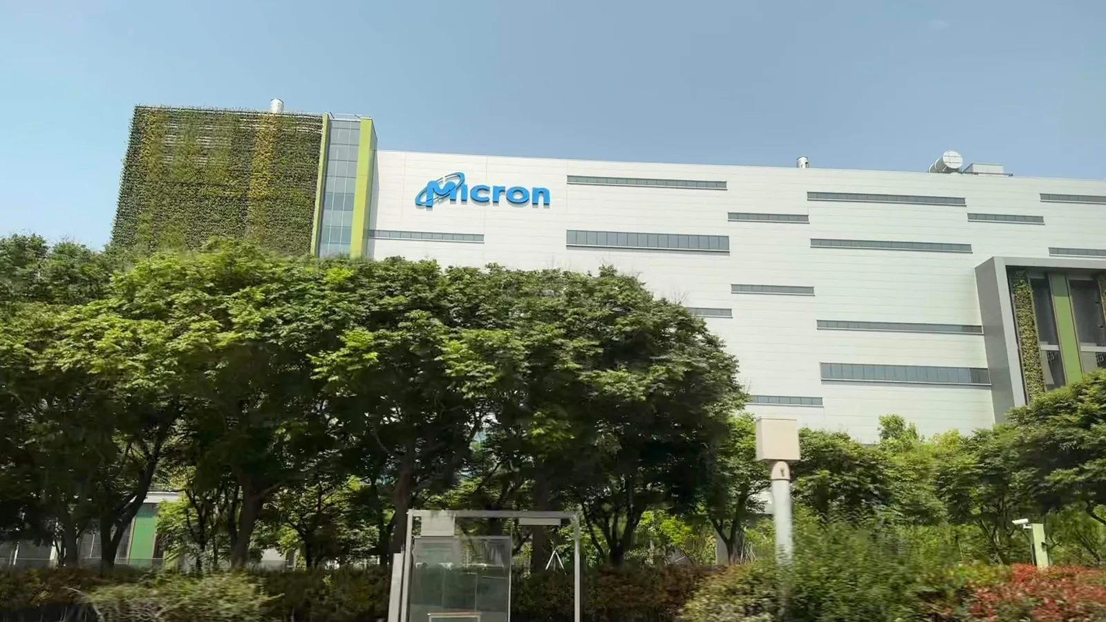 Micron memory chip fab building in Taichung, Taiwan, behind a row of trees