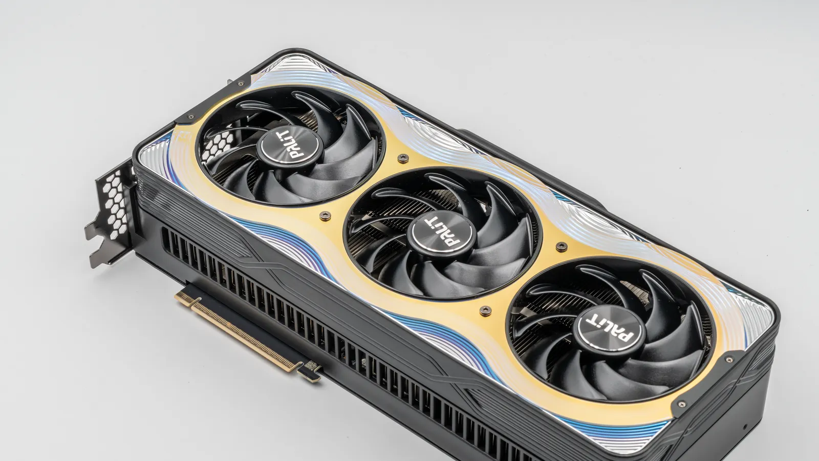 A Palit GeForce RTX 5090 GameRock graphics card with three fans on a white surface.