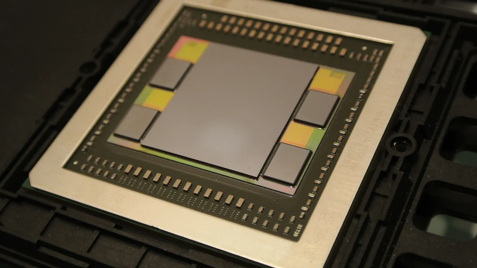 An AMD Fiji GPU package with the graphics die surrounded by four HBM memory stacks on an interposer.